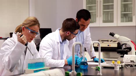 young scientist using pipette to put chemical in test tube