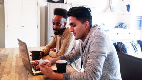 Pareja-Gay-Usando-Laptop-Mientras-Toma-Café