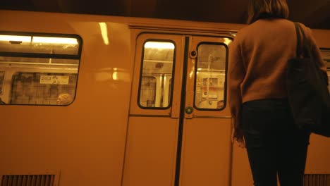 Females-walking-towards-a-train-as-it-slows-down-at-Stadtmitte-station-in-Berlin