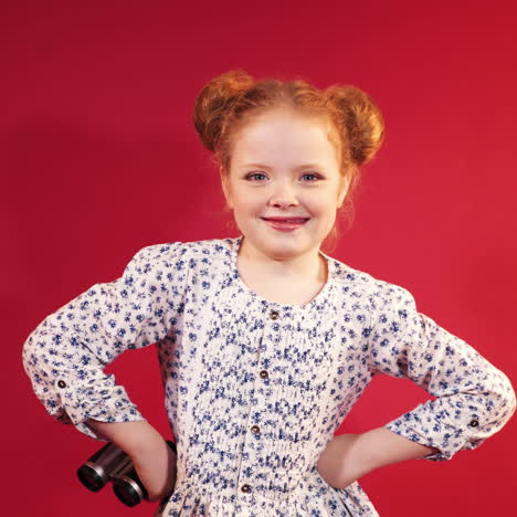 little girl in studio posing on camera and showing thumbs up. emotions of children.