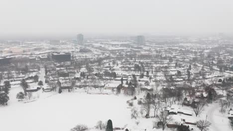 aerial, rural snow covered suburb community during winter