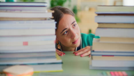 a student, terrified by the amount of studying, pushes aside a stack of books and is surprised