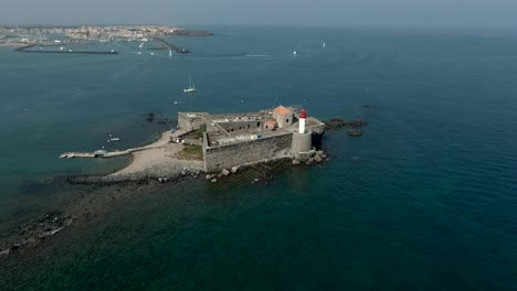 aerial panorama shooting of an old sea fort with a lighthouse on small island