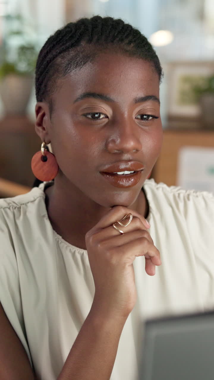 Focused Young Black Woman Working and Smiling on Laptop