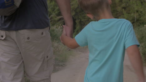 child and grandpa hiking in the woods