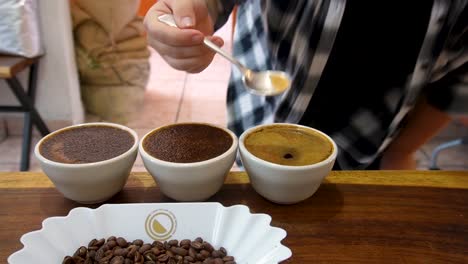 slow motion shot of coffee taster testing a sample