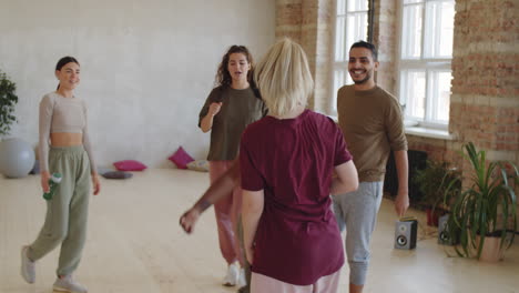 dance teacher greeting positive students before class