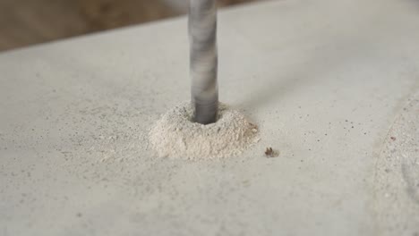 close up of a pile of shavings forming around a metal drill