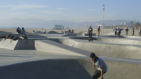 skaters enjoying a sunny day at venice beach skatepark, california