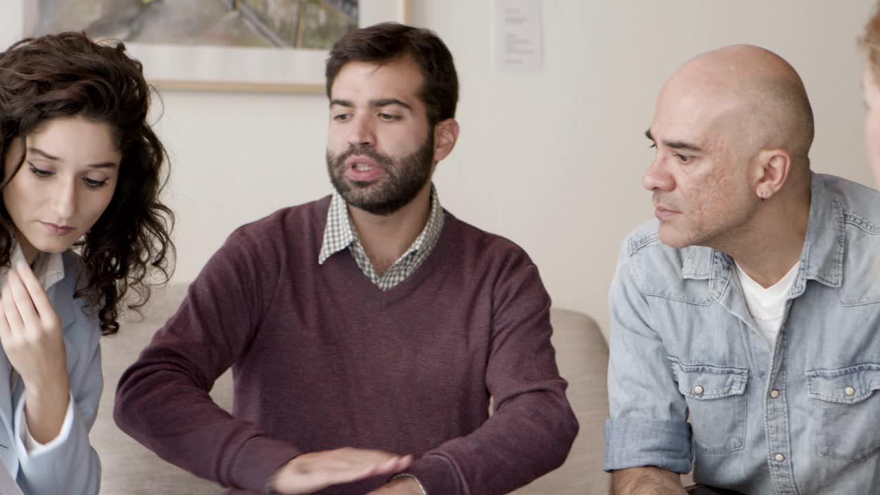 propietarios concentrados hablando con el diseñador de interiores