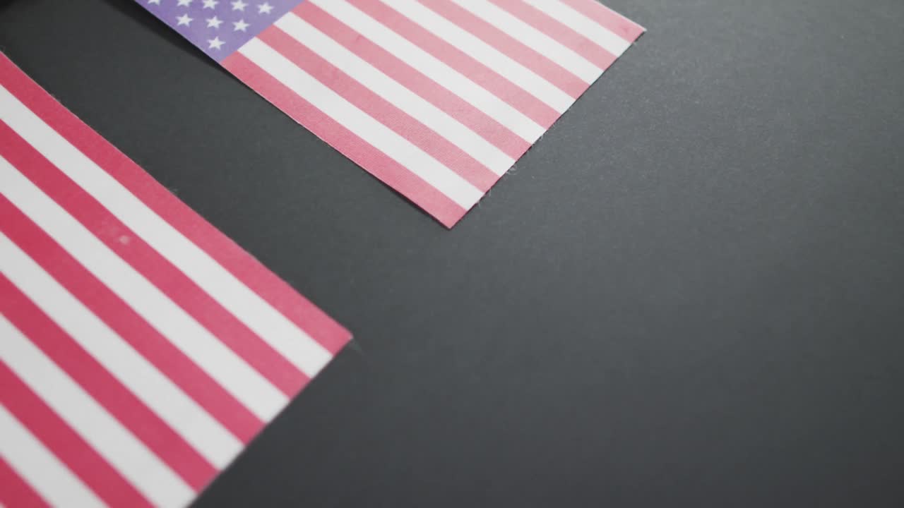 Video of three flags of united states of america on grey background