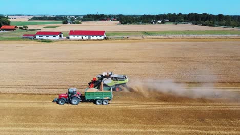 aerial shot of combine loading off corn grains into tractor trailer-8