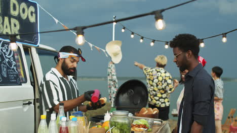 Food-Truck-Seller-Cooking-Hot-Dogs-and-Speaking-with-Customers