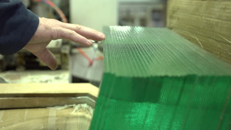Picking-glass-panel-from-the-perfectly-stored-row-in-the-workshop