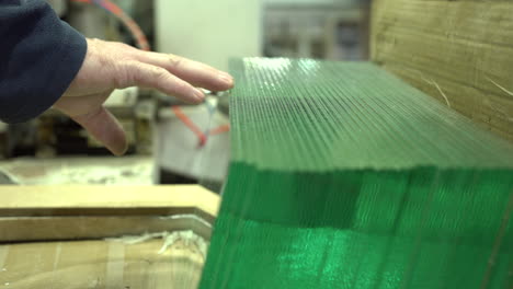 picking glass panel from the perfectly stored row in the workshop