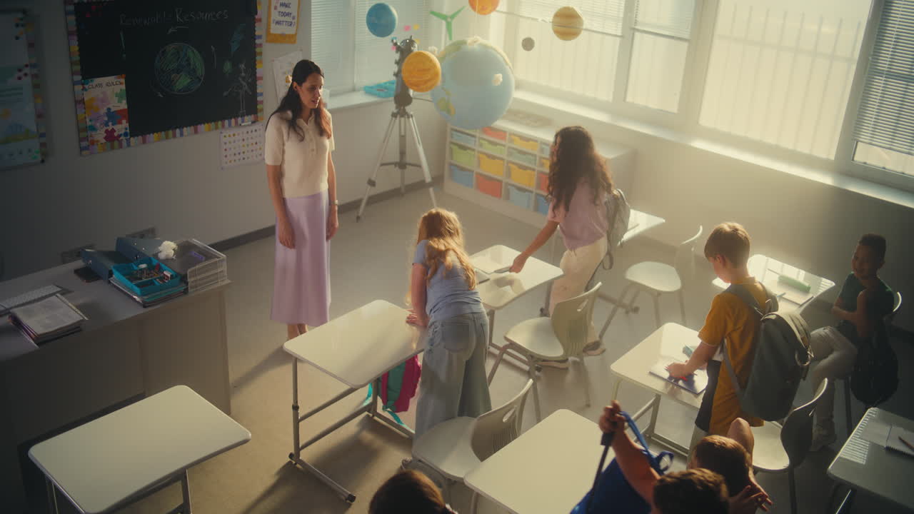 Elementary School Students Entering Classroom Unpacking Backpacks with School Supplies