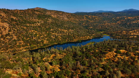 amazing long lake in the mountains covered with trees. sunny day in sierra national forest, california, usa. aerial view.
