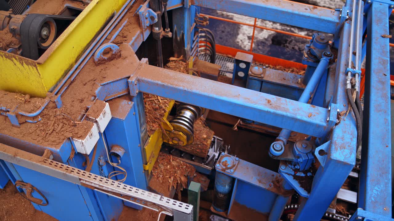 Sawmill. Process of machining logs in a machine different view closeup. Removing bark from logs. Closeup.