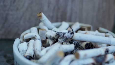 smoking cigarette in ashtray on table