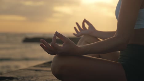 Thumb-and-index-fingers-touching-in-zen-meditation-pose-of-female-hands,-dusk