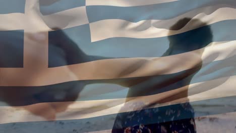 Animation-of-waving-greece-flag-over-group-of-friends-on-the-beach