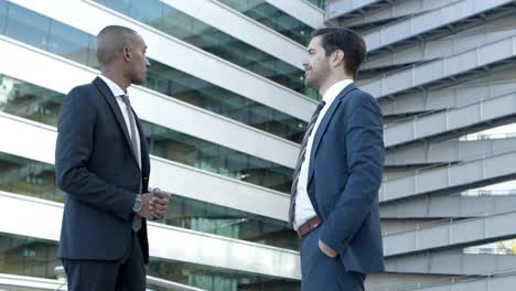 multiethnic male colleagues discussing outdoors