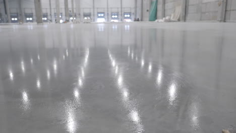 interior of a new industrial warehouse with a polished concrete floor under construction