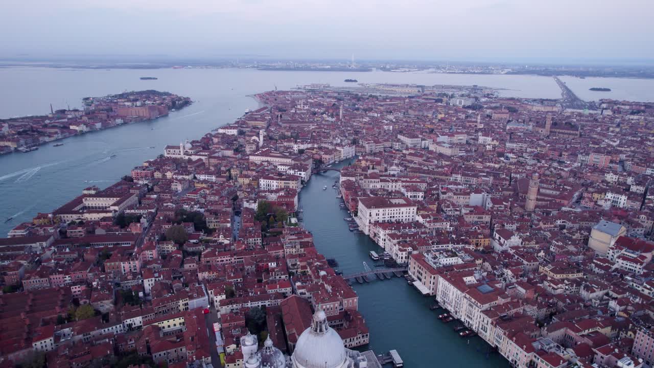 Venice’s Grand Canal at sunrise with boats and town views