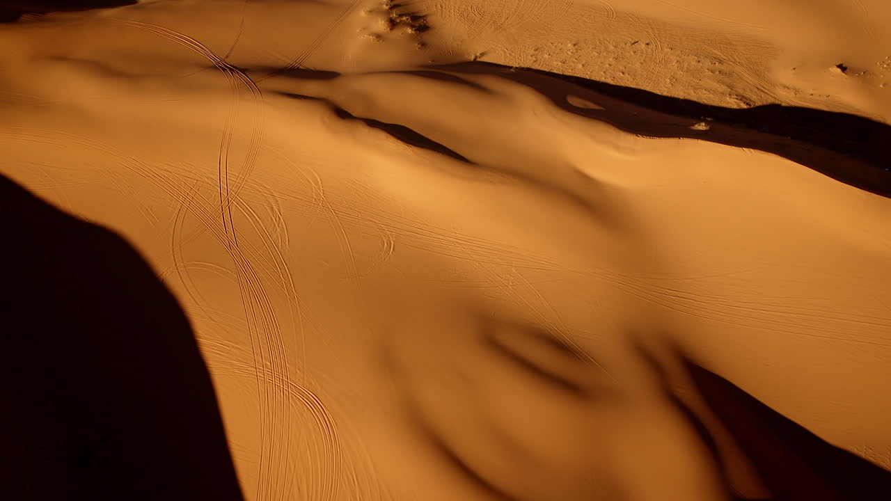 High-altitude view looking down on the sculptural beauty of the Pink Sand Dunes State Park.