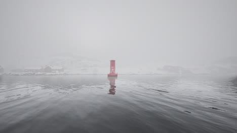 red buoy in foggy water