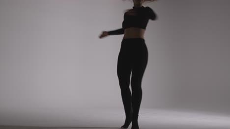 Full-Length-Studio-Shot-Of-Young-Woman-Doing-Dance-Practise-Against-Grey-Background-5