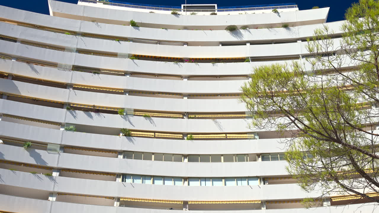 A white, large, pyramid-shaped building in the Marina Baie des Anges complex in Villeneuve-Loubet, France