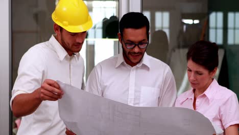 team of architects going over blueprints