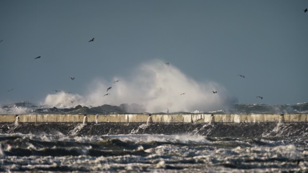 Powerful Waves Crashing Against a Lighthouse and Pier