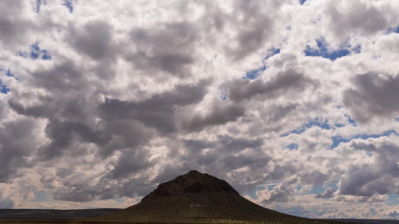 Timelapse Moody Low Clouds Passing Over Isolated Butte, Mojave Desert