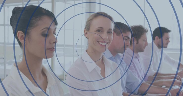 Team sitting business meeting with concentric overlay appearing, blonde woman glancing then smiling
