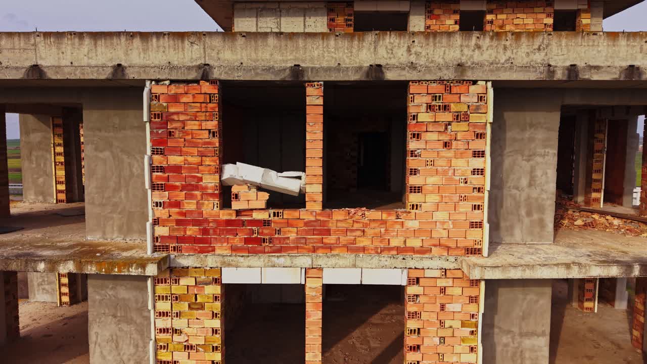 Overview of a building under construction in a rural area