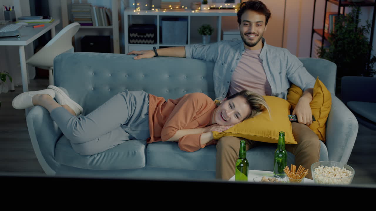 Couple Relaxing and Watching TV at Home