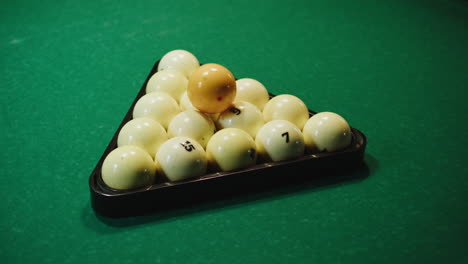billiard balls in a triangle on a green table