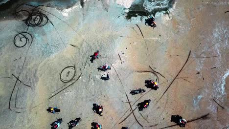 Motorcycles-Viewing-The-Red-Water-Of-Lake-Magadi-Due-To-The-Proliferation-Of-Halobacteria-In-Kenya,-East-Africa