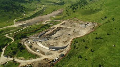 Top-down-aerial-drone-shot-of-a-dam-construction-site-in-the-alpine-mountains