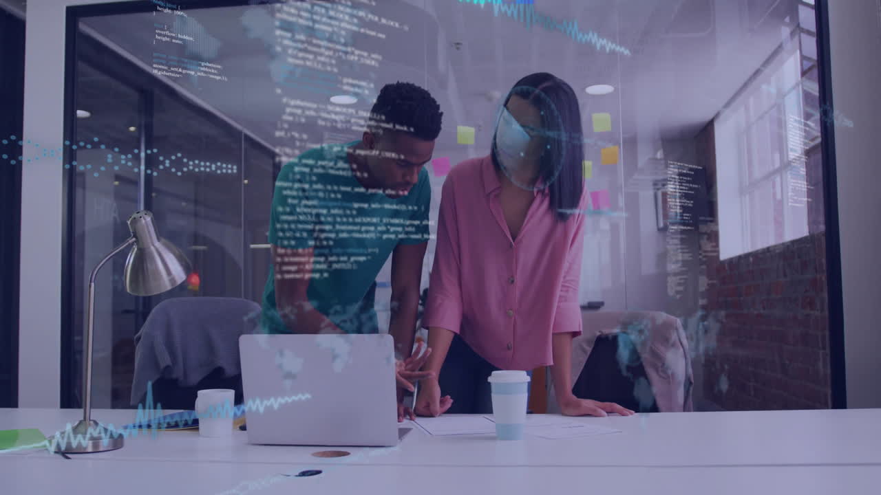 two developers collaborating at table in tech office with sticky notes and code overlay animating