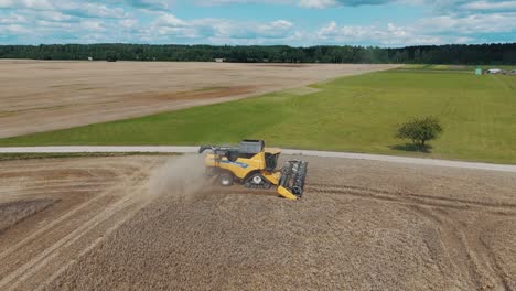 25 august 2024 penkule, latvia - aerial view of combine harvester at work. summer field work on the farm. top view of combine gathering corn or wheat crop.