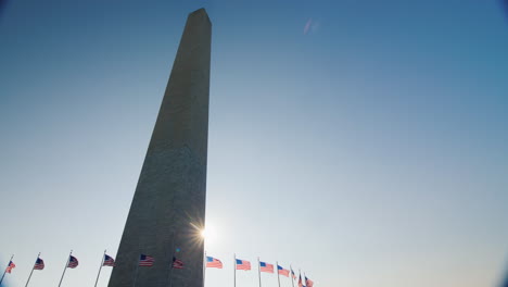 sun shining behind washington monument