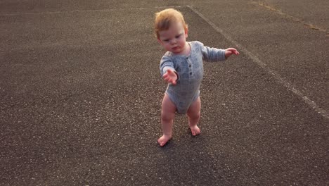 toddler takes first steps falls on butt rises to get back up