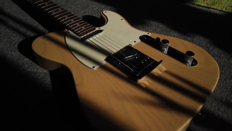 medium shot panning across a custom classic honey blonde fender telecaster