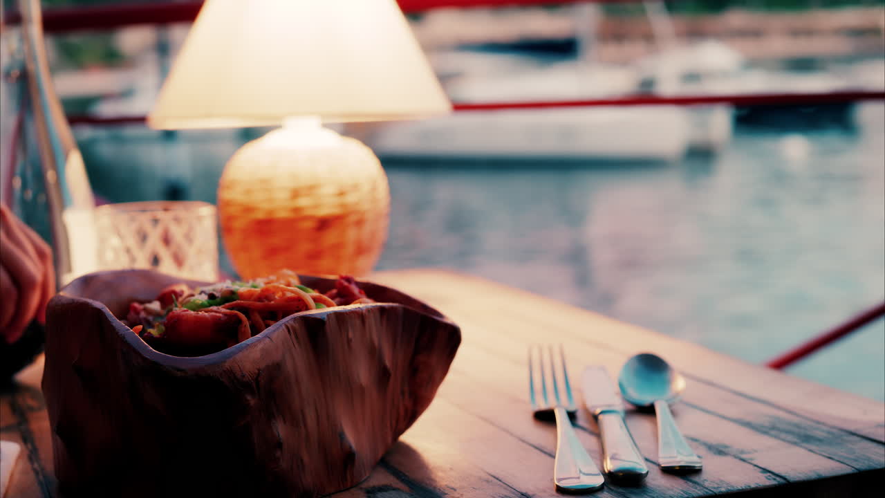 Close up view of a lamp on a set table at a restaurant near a port in the south of France