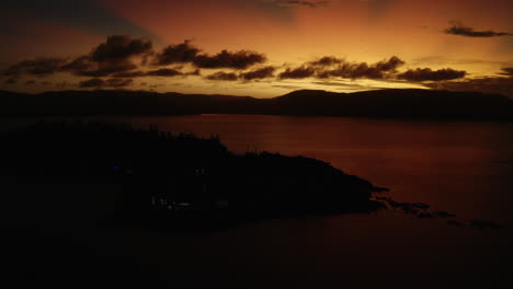 pan up shot to reveal sunset with bright orange sky and clouds