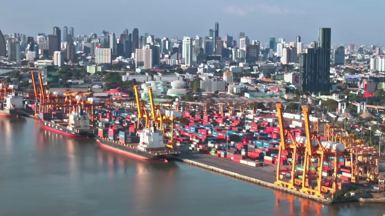 View of Bangkok skyline with shipping containers along the river
