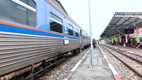 train approaches platform in kanchanaburi, thailand